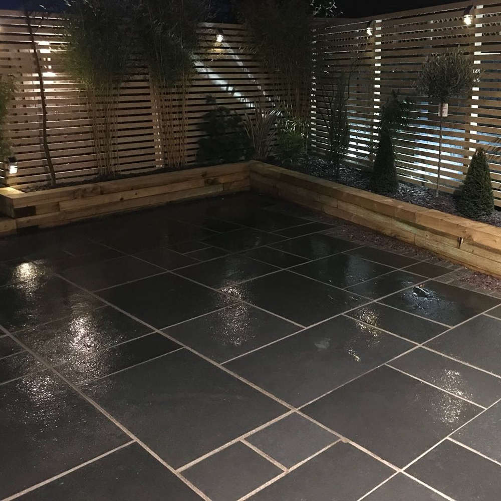 Black Natural Riven Limestone Patio Slabs - wet