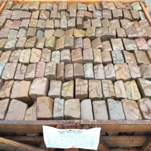Raj Green Tumbled Cobbles stacked in crate
