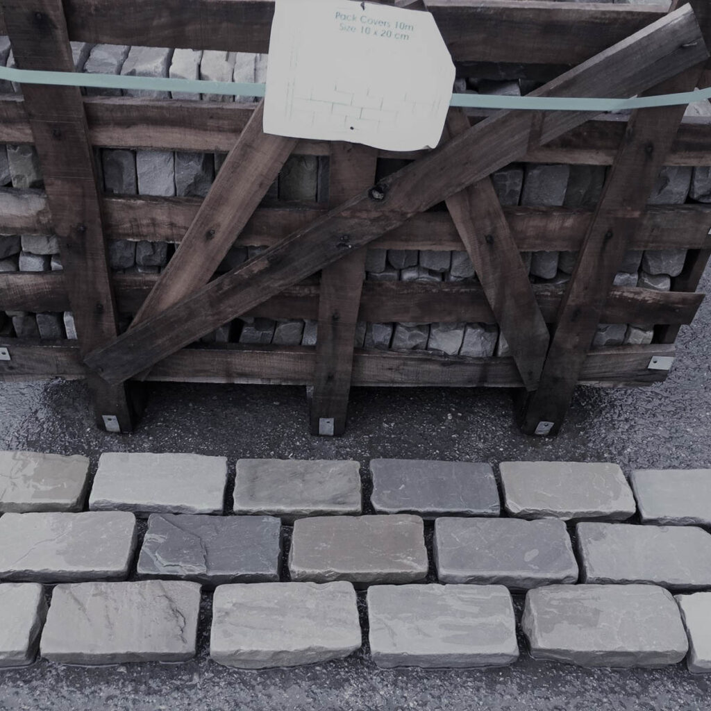 Kandla Grey Tumbled cobbles laid on the floor in a brick-bond pattern