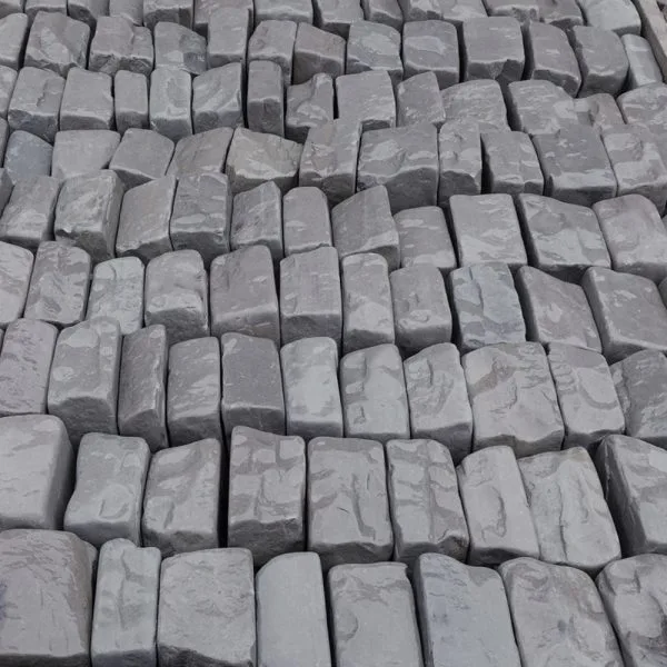 Kandla Grey Tumbled Cobbles 100x100 stacked in a crate